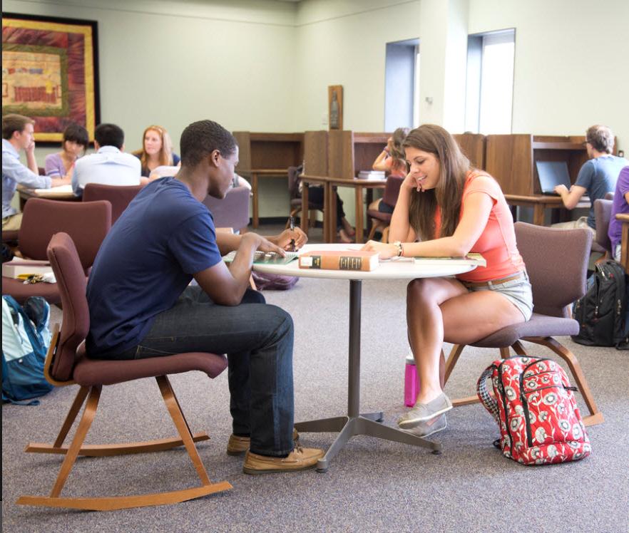 Woman helping man understand text